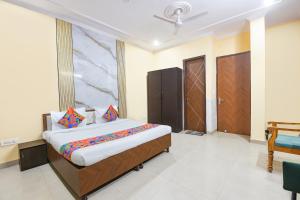 a bedroom with a large bed in a room at FabHotel Sager Inn in Gurgaon