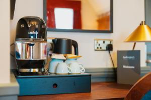 a coffee maker sitting on top of a table at The Crown & Greyhound by Innkeeper's Collection in London