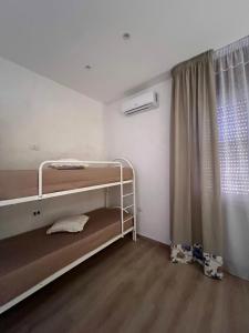 a room with two bunk beds and a window at Stay & Fly in Naples