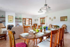 a dining room and living room with a table and chairs at Villa Son Tretze by Villa Plus in Biniparrell