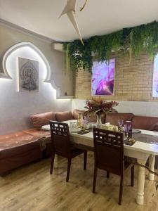 a living room with a table and a couch at INFINITY Hotel&Spa in Almaty
