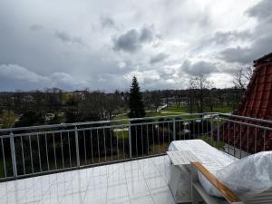 a balcony with a table and a view of a field at ME LIVING Villa am Kurpark - Design Apartments in Bad Salzuflen