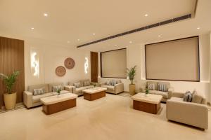 a waiting room with couches and tables and a screen at Keys Select by Lemon Tree Hotels, Amritsar in Amritsar +39 photos
