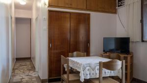 a dining room with a table and a television at House Katarina by Villas Guide in Blato