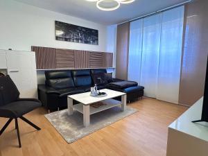 a living room with a couch and a table at Wasserburg 1 I Familienfreundlich - Ruhig & Erdgeschoss I Parkplatz inkl in Paderborn