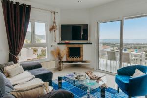 a living room with a couch and chairs and a tv at WELCS CASA 335 EMP con jacuzzi y terraza in Selva de Mar +32 photos