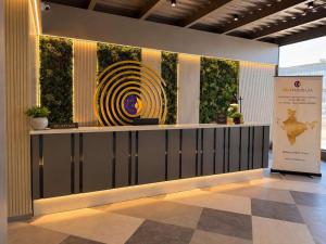 a lobby with a large painting on the wall at Click Hotels Lite Chakan in Pune