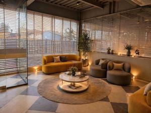 a living room with two couches and a table at Click Hotels Lite Chakan in Pune