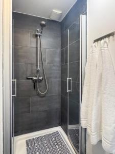 a bathroom with a shower with a glass door at City-Apartment Timeless in Berlin