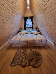 a bedroom with a bed in a small room at Căsuțele EliMar in Chirleşti