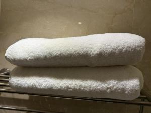 three towels stacked on top of each other on a rack at كلاديوم in Medina