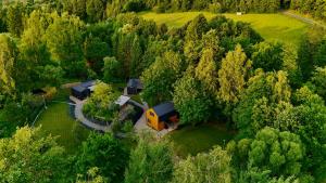an aerial view of a house in the middle of a forest at Domki pod Krakowem - Stare Sady in Kopytówka