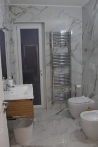 a bathroom with a sink and a toilet and a mirror at TedHouse in Praia a Mare +14 photos