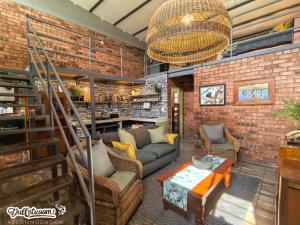 a living room with a brick wall at Olive Branch in Dullstroom