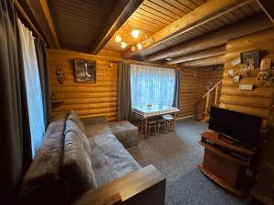 a living room with a couch and a table at Teremok in Tatariv