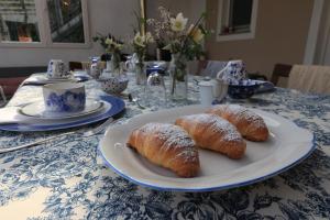 two croissants on a plate on a table at Lùlù Guest House in Dernice