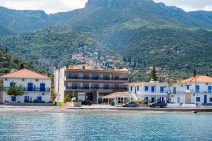 a group of buildings next to a body of water at KAMVISSIS HOTEL in Tyros