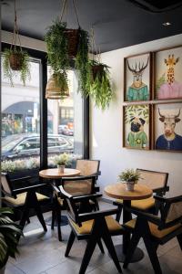 two tables and chairs in front of a restaurant at Bayer's City Hotel in Munich