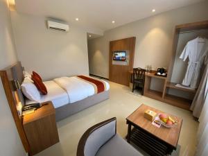a hotel room with a bed and a table at Landmark Narayani in Chitwan