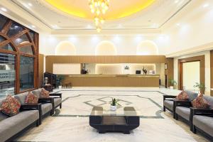 a lobby of a hotel with couches and a table at Hotel Nivaara By VYDA in Tirupati