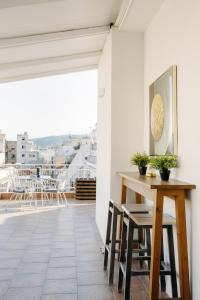 a room with a table and chairs on a balcony at Nuance Residences - Cresento in Volos