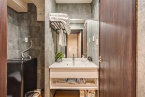 a bathroom with a sink and a mirror at YCYC Hotel in Tokyo +128 photos