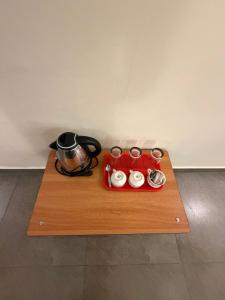 a tray with a pot and a tea kettle on it at Bliss Stay in Mūvattupula