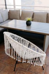 a coffee table with rattan baskets in front of a couch at Nuance Residences - Cresento in Volos