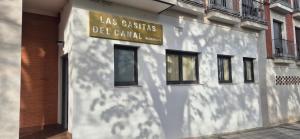 a building with a sign on the side of it at Las Casitas del Canal Acueducto in Segovia +2 photos