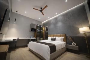 a bedroom with a large white bed and a desk at "Earthy Couple Retreat Near Taj Mahal" Private Spa Jacuzzi in Agra +77 photos