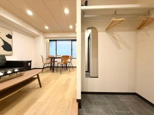 a living room and a dining room with a table at YCYC Hotel in Tokyo