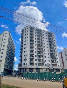 a tall white apartment building on a city street at The perfect Hideout in Nairobi