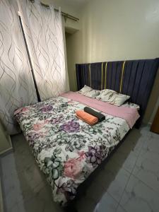 a bed with a blanket and two towels on it at The perfect Hideout in Nairobi