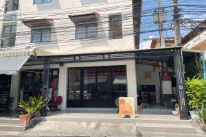 a store front with a sign in front of it at Dad N Mom's House By Thongnak Apartment in Pattaya