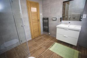 a bathroom with a sink and a shower at Penzión ÁTRIUM in Prešov