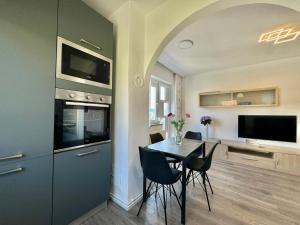 a kitchen with a table and chairs and a television at Adrijana 2 in Krk