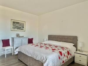 a bedroom with a large bed with red pillows at Adrijana 2 in Krk