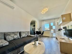 a living room with a couch and a table at Adrijana 2 in Krk
