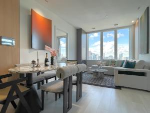 a living room with a table and chairs and a couch at Luxurious Panoramic Skyline Penthouse 2Bedrooms Suites CN Toronto Downtown in Toronto