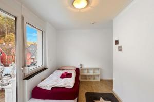 a small bedroom with a bed and a window at Loft Nagoldtal in Pforzheim