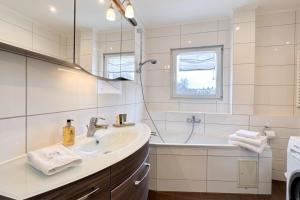 a white bathroom with a sink and a bath tub at Loft Nagoldtal in Pforzheim +51 photos