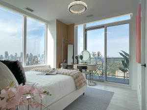 a bedroom with a bed and a large window at Luxurious Panoramic Skyline Penthouse 2Bedrooms Suites CN Toronto Downtown in Toronto