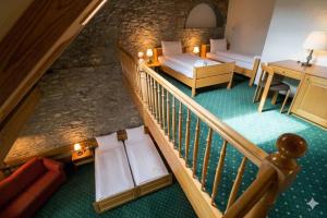 a room with a staircase with a couch and a table at Hotel guter Hirte in Huttwil