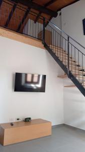 a room with a staircase and a wooden table at Appartamento Trezzo sull'Adda in Trezzo sullʼAdda