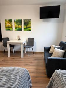 a living room with a couch and a table at The Country Stop Apartment in Łęki