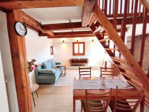 a living room with a staircase and a table and chairs at Globetrotter Apartments in Konstanz