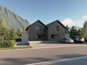 a black house with two cars parked in a parking lot at NOOK - Nature Hideaway in Bad Aussee
