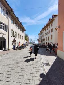 a group of people walking down a street at Globetrotter Apartments in Konstanz