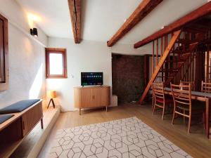 a living room with a staircase and a table and chairs at Globetrotter Apartments in Konstanz