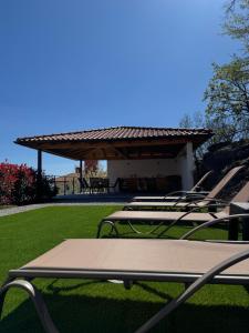 a group of lounge chairs sitting on a lawn at Villa Petra in Kastav